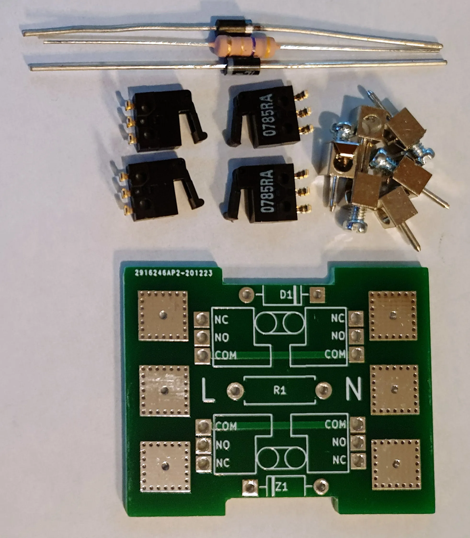 The parts laid out: a diode, resistor and zener, four micro switches, the Elko rocker hardware, and the bare board silkscreened with NC/NO/COM pads on both sides